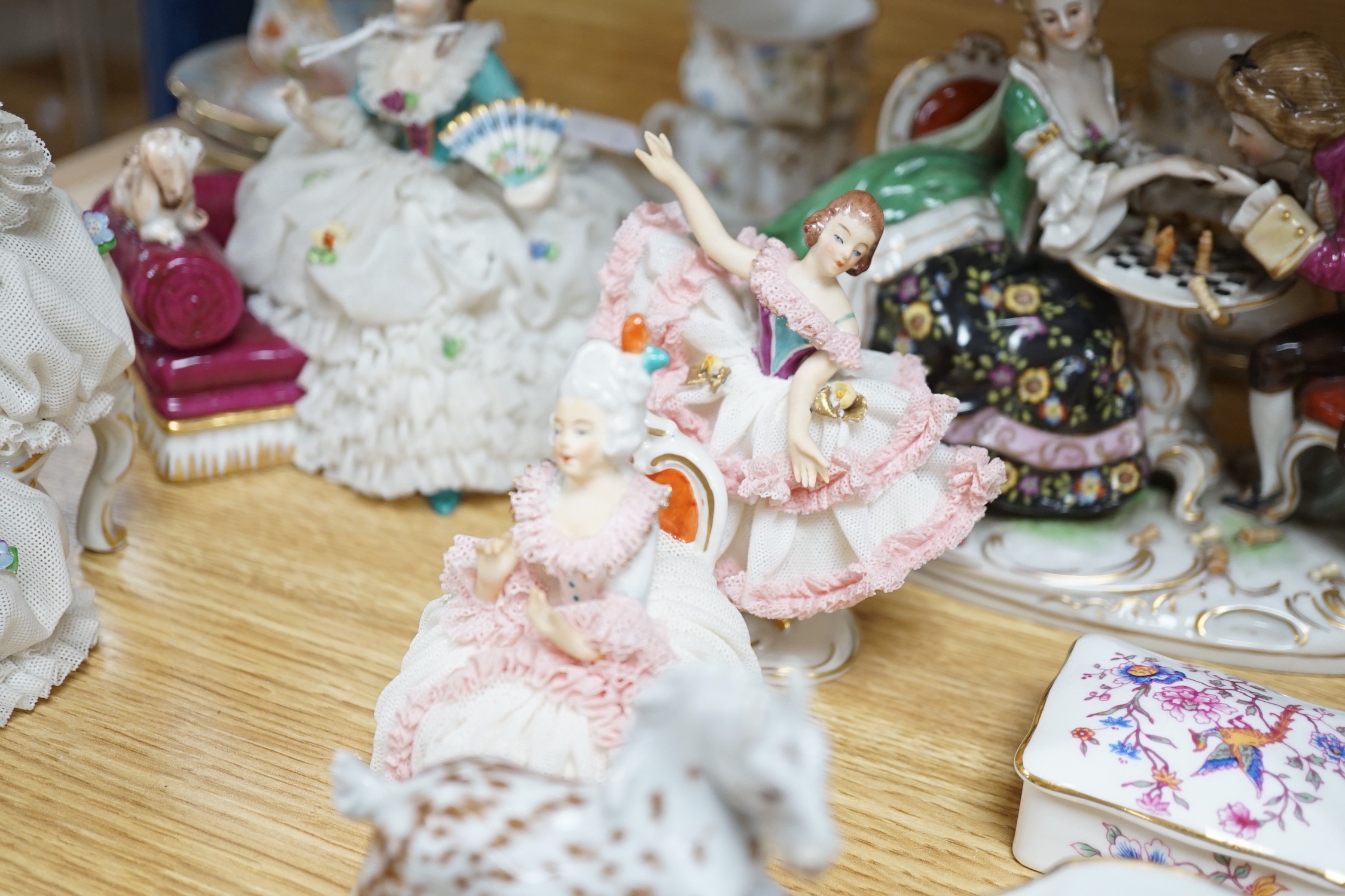 A group of Continental porcelain cabinet cups and saucers, a vase, crinoline figures and a Meissen horse, horse 9 cms high